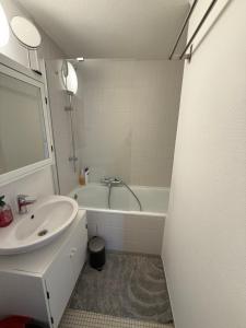 a bathroom with a sink and a bath tub at Lovely condo next to European Area in Brussels