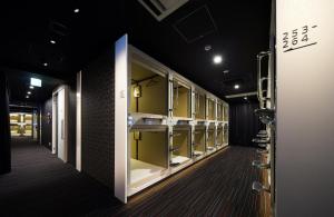 a dressing room with a row of sinks and mirrors at Tokyo Ariake Bay Hotel in Tokyo