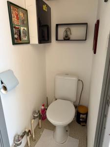 a small bathroom with a toilet and pictures on the wall at Lovely condo next to European Area in Brussels
