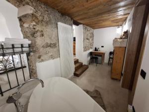 a bathroom with a white tub and a sink at La SUITE delle Scuderie, con Vasca da bagno in stanza, PetFiendly con Area Cani in Baselga di Pinè +42 photos
