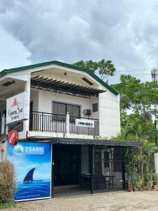 a building with a shark sign in front of it at Roccksar Pension House in Puerto Princesa City