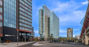 two tall glass buildings in a city at PLAZA Premium Almere in Almere
