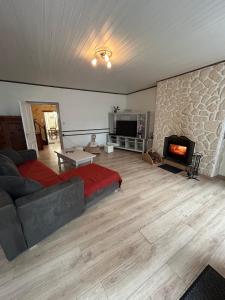 a living room with a bed and a fireplace at Maison avec jardin in Saint-Amand-sur-Sèvre