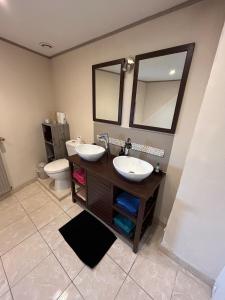 a bathroom with two sinks and a toilet at Maison avec jardin in Saint-Amand-sur-Sèvre
