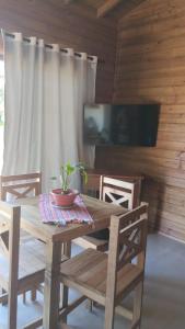 a wooden table with a potted plant on top of it at Residencial Bambu in Garopaba