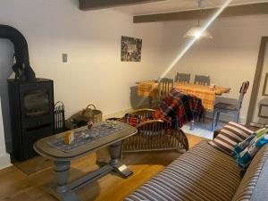 a living room with a couch and a table at Cozy cottage getaway Holse in Brenderup