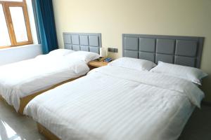 Hongge Hotel - Harbin Taiping Airport客房内的一张或多张床位