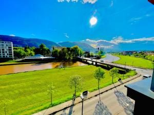a view of a park with a river and a city at VIP Apartment FOUR in Sarajevo