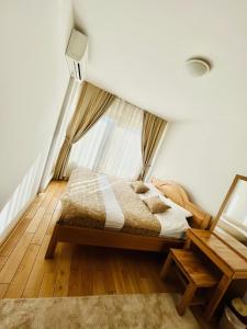 a bedroom with a bed and a window at VIP Apartment FOUR in Sarajevo