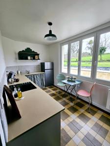 a kitchen with a table and chairs in a room at Le Clos Bernadette in Boissy-le-Bois +14 photos