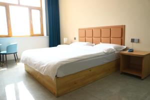 Hongge Hotel - Harbin Taiping Airport客房内的一张或多张床位