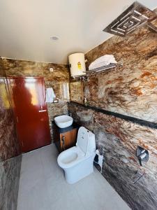 a bathroom with a toilet and a sink at Panchwati Farms Homestay in Almora +80 photos