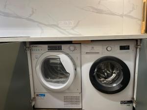 a washer and dryer sitting under a counter at souvenirs rignacois in Rignac