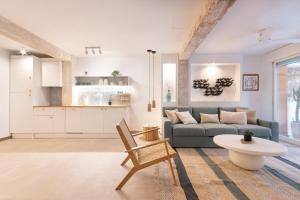 a living room with a couch and a table at K-DOCK by Nuka Homes in Jávea