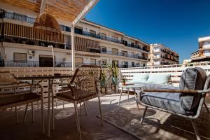 a patio with chairs and tables on a building at K-DOCK by Nuka Homes in Jávea