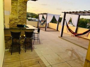 a patio with a table and chairs on a balcony at Top-Flat @ Bella Maré in Maragogi