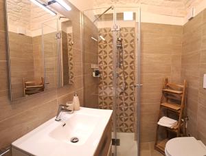 a bathroom with a sink and a shower at Palazzo d'Itria - Luxury holiday in Valle d'Itria in Martina Franca