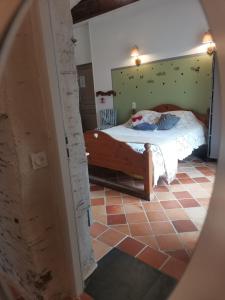 a bedroom with a bed in a room at chambres d'hôtes "DINEDORT" in LʼAiguillon-sur-Vie