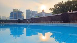 a swimming pool with a city skyline in the background at NAM Kemayoran in Jakarta