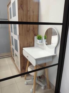 a bathroom with a sink and a mirror at Cozy Home and Staycation Resort at Hill Residences Novaliches QC in Manila