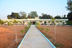 a walkway in front of a large building at Hotel Vijay Greens in Orchha