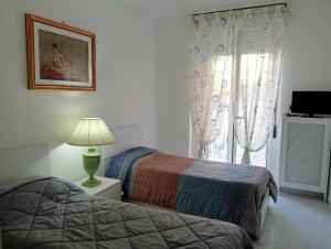 Postel nebo postele na pokoji v ubytování Appartamento confortevole per famiglie