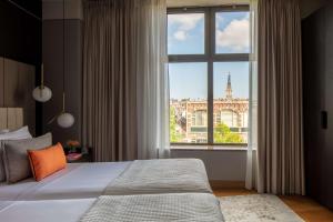 Ein Bett oder Betten in einem Zimmer der Unterkunft Anantara Grand Hotel Krasnapolsky Amsterdam