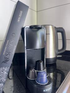 a coffee maker on a counter next to a knife at Lucky Lemons - Boutique Houses Madeira - 2 in Estreito da Calheta