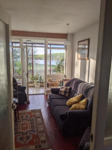 a living room with a couch with pillows on it at Dry Harbour in Enniskillen
