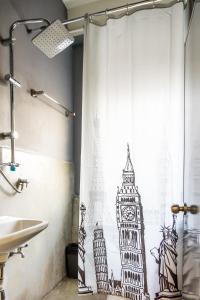 a bathroom with a shower curtain with a clock tower at Love CNX Guesthouse in Chiang Mai
