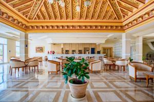 a large room with chairs and a bar in a building at Iris Hotel & Thalasso in Taguermess