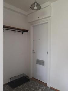a room with a door and a shelf on the wall at Peaceful studio in Vantaa in Vantaa
