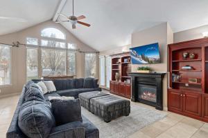 a living room with a couch and a fireplace at Riviera Retreat in Salt Lake with Private Hot Tub and Theater in Millcreek