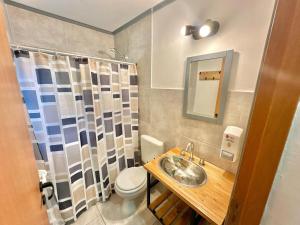 a bathroom with a sink and a toilet at Hostel TRUFA in San Carlos de Bariloche