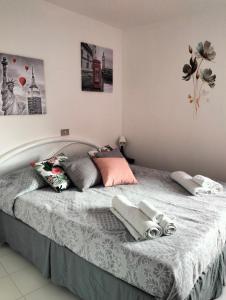 a bed with two pillows on it in a bedroom at La casa Sul Lago in Colledimezzo +28 photos