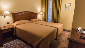 Postel nebo postele na pokoji v ubytování Hotel Bramante