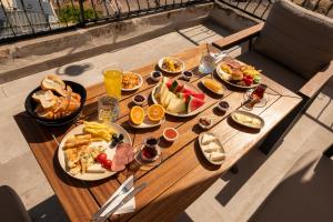 a wooden table with plates of food on it at Ages in Cappadocia in Uçhisar +81 photos