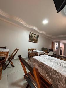 a room with two beds and a table and chairs at Hotel Dallas Ipiranga in Bom Jesus da Lapa +3 photos