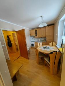 a kitchen and dining room with a table and chairs at Apartment Ski Sara Pokljuka in Bled +12 photos