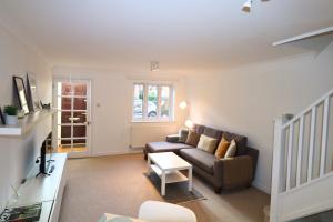 a living room with a couch and a table at Warfield Charming Three Bedroom House in Warfield