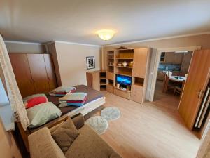 a small room with a bed and a couch at Apartment Ski Sara Pokljuka in Bled