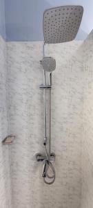 a shower with a chair in a bathroom at Villa Ngorane in Somone