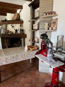 a kitchen with a red sewing machine on a counter at Villa Gorghe in San Severino Lucano +30 photos