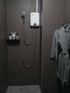 a bathroom with a blow dryer on a wall at SK Hometel Samui Airport in Bang Rak Beach