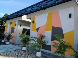 a mural on the side of a house at SK Hometel Samui Airport in Bang Rak Beach