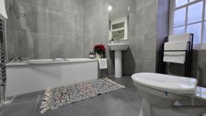 a bathroom with a tub and a toilet and a sink at Soho Guest House Room 6 in London