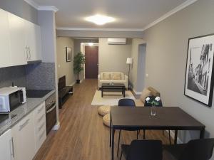 a living room with a kitchen and a dining room at Ferreiros 184 in Funchal
