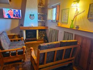 a living room with two chairs and a fireplace at Erbanova in Sila in Camigliatello Silano