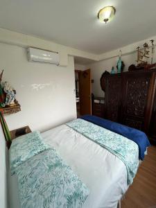 a bedroom with a bed with blue and white sheets at Confort Club 907 - Barra Velha- SC in Barra Velha +19 photos