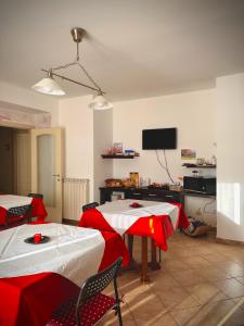 a living room with two tables and a tv at Il corbezzolo in Linguaglossa